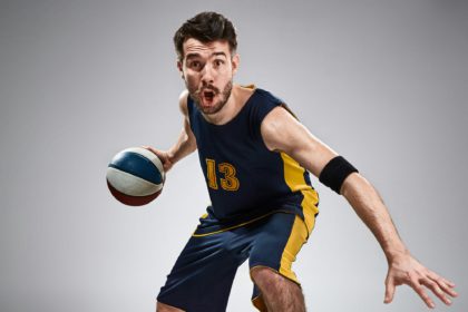 Full length portrait of a basketball player with ball