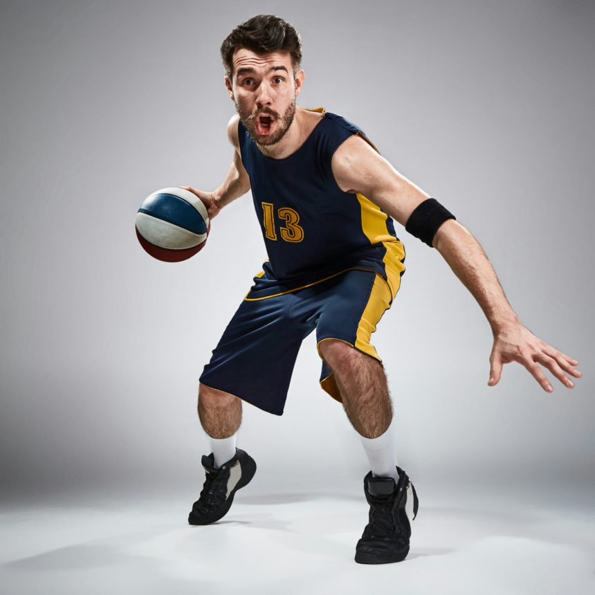 Full length portrait of a basketball player with ball