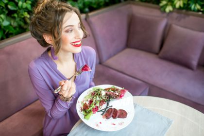 Woman with healthy food at the restaurant